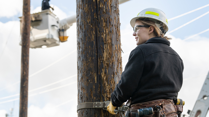 woman lineworker on pole